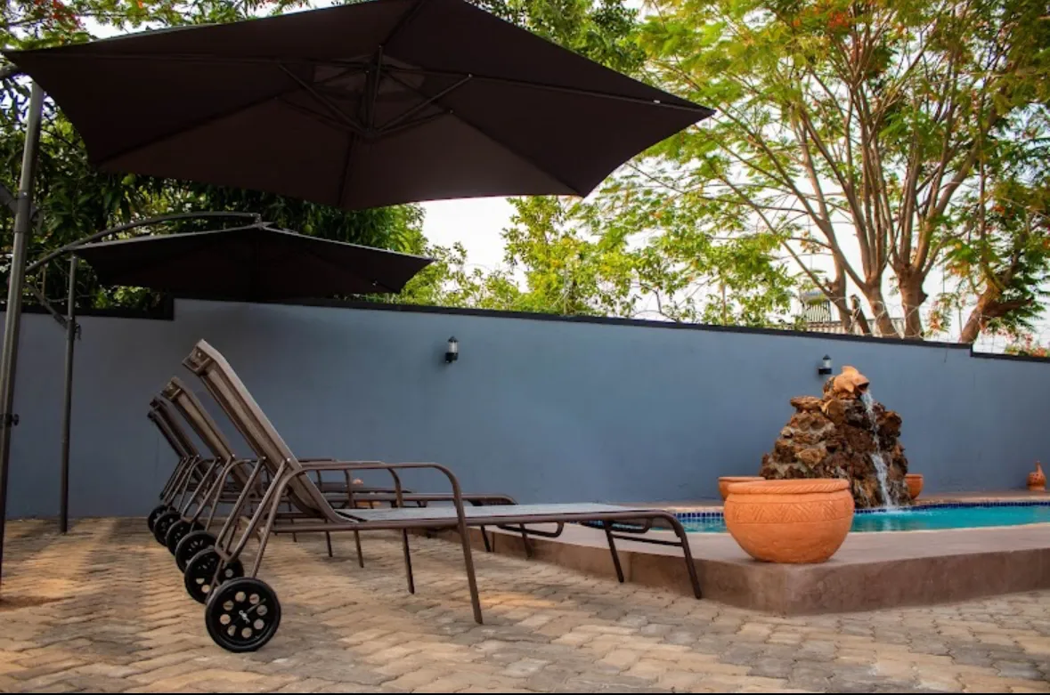 Pool loungers at dusk
